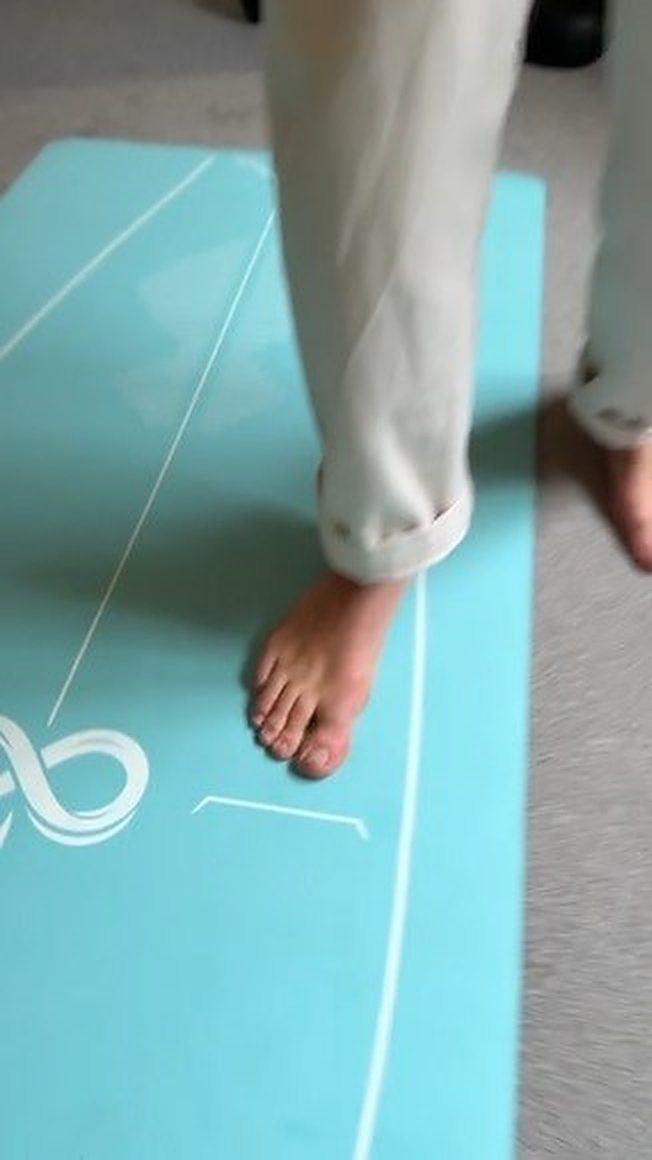 Un pied nu posé sur la surface du tapis